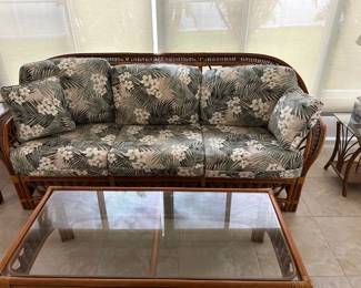Like new, barely used Rattan upholstered sofa. The coffee table, end table & lighted end table are all like new Never outside
