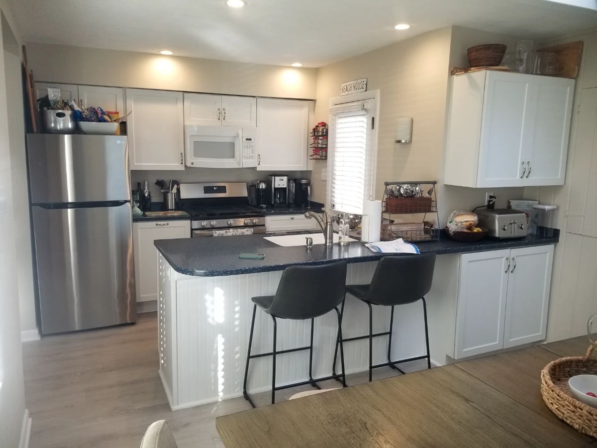 Thoughtfully designed kitchen makes the most of a small space with contemporary white cabinets