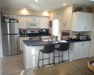Thoughtfully designed kitchen makes the most of a small space with contemporary white cabinets