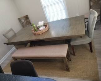 Dining set seats 8; includes table with leaf (as shown); two chairs & two upholstered benches. NOTE: upholstered chairs not included