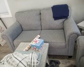 Love seat in a neutral gray matches sleeper sofa