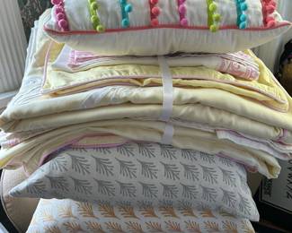 Serena and Lily throw pillows and linens for twin beds.