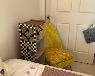 Antique wicker chair and McKenzie Child’s type bookcase