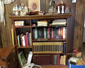 wood bookcase $80., books, steins, vintage ceramic ashtrays, half moon table $60