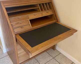 Secretary desk slides out and raises desk top.