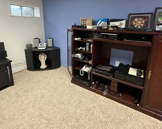 Large Entertainment Center; Corner Cabinet; Black Side Table; Cambridge Soundworks Sound System- The Surround 5.1; Sharp Compact Audio System XL-1600;Pandigital 5" LCD Digital Photo Frame; Satellite Speaker; Roku 3; Universal Turntable Drive 942-472; GE Big Button Speaker Phone; Breaker Corp. Transmitter Model 13-500; Panasonic Digital Cordless Answering Machine; Digitech DSP16 Effects Processor; Eiki Multi Media Projector LC-XB100A; Panasonic DVD-X410; Samsung DVD C-500; Nintendo Game Cube Power Cord; Nintendo Game Cube Controller; PS2 Game Codes Game Shark; Nintendo Game Cube Driven Game; AT&T Cordless Phone w/ Answering Machine; Desk Phones; Toshiba 4 Head VHS Player M5600; Sony Stereo Turntable System PS-LX3006SB; Marantz A/V Surround Stereo Receiver SR-585; Cords; Sharp Compact Audio System XL-1600; Grundig FR200 AM/FM Shortwave Radio