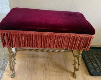 Victorian Style Red Velvet Upholstered Stool with Fringed Trim and Ornate Iron Legs