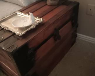 Antique trunk with wheels on the bottom. A lot of storage.