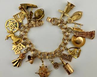 14K gold charm bracelet. 14K and 18K gold charms. Charms will be sold individually.