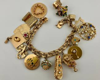 14K gold charm bracelet. 14K and 18K gold charms. Charms will be sold individually.