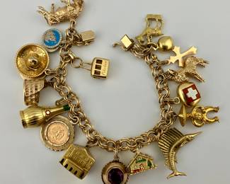 14K gold charm bracelet. 14K and 18K gold charms. Charms will be sold individually.