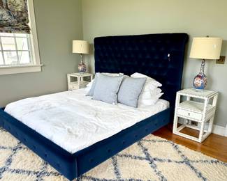 Anthropologie King Blue Velvet Bed, dreamy grass cloth side table, Asian inspired lamps with lucite bases and we think this rug is by Stark