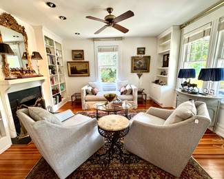 Dueling swivels chairs, antique side tables, antique bamboo coffee table, Restoration Hardware day bed with linen slipcover, antique oil paintings and Drexel MCM side tables