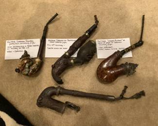 These four German pipes are hand carved and from 1880.  Each is distinctly different.  Caps on bowls are silver on two.  Very rare and collectible
