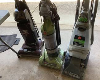 Three different vacuum cleaners.