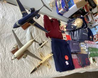 TWA and Boeing jet models plus a blanket, hat, sweater, towels, playing cards, doll.