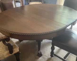 Antique centennial style mahogany carved pedestal table. 4 leaves