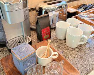 Cuisinart coffee maker (pod), walnut tray, cream and sugar, Crate & Barrel coffee mugs and SMEG toaster