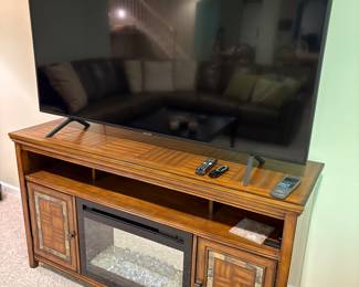 Samsung 65" TV and media console cabinet with fireplace