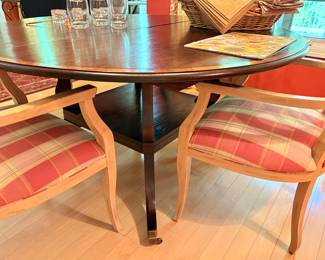Another view of the dining table with lower tier and caster feet and side view of the dining armchairs