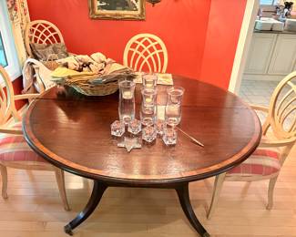 Round table with caster feet with an additional leaf (extending to oval), dining chairs (8 available) sold separately, and glass candle holders