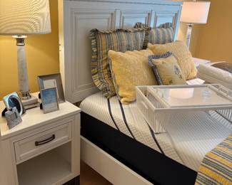 Another view of the Queen bed, mattress, nightstands, lamps, linens, and tray table
