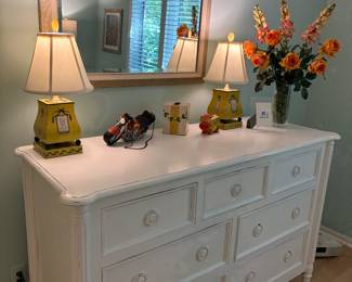White dresser, yellow occassional dresser lamps, and decor