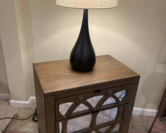 Nightstand with mirrored front drawers, and black lamp