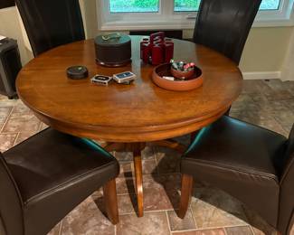 48" inch round pedestal table with leaf and pads and 6 leather side chairs (sold separately) and poker chips