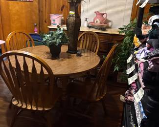 Several antique dining room tables with chairs