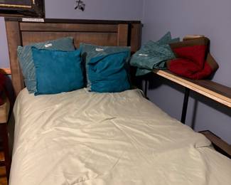 Two twin beds with assortment of bed linens