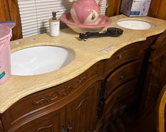 A beautiful antique bathroom, vanity with double sinks and mirrors