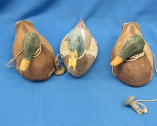 Lot 145. Three vintage duck decoys, two are painted cork and one is canvas-covered cork