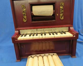 Lot 291. J. Chein & Co. toy player piano and 6 additional rolls. Powers up