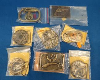 Lot 41. Eight belt buckles from fraternal organizations and one from Smith and Wesson. Some are marked as brass