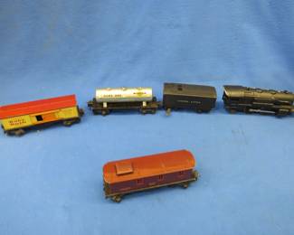 Lot 258. Vintage Lionel train collection including a Marx Wabash Truss bridge, tracks, 258 engine, junior transformer, 1689E engine, Baby Ruth cars, and more.