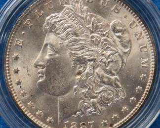 Lot 407. 1887 P Morgan silver dollar from a boxed set. All coins from this set are being sold individually in this auction.