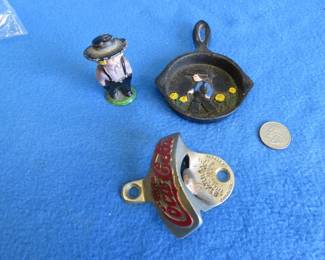 Lot 251. A cast iron Amish figurine and a mini cast iron skillet