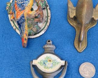 Lot 192. Cast iron door knockers and a brass paper clip goose
