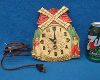 Lot 104. Dutch-themed non-working electric clock for parts or repair. Motor hums but hands don't turn. At least its right twice a day.