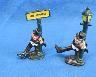 Lot 194. Two cast iron drunk men leaning on posts.