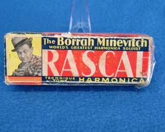 Lot 138. Borrah Minevitch 4" technique-tone harmonica and box made in Germany. Some holes do not sound. Box in fair condition.