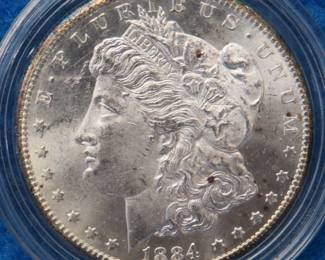 Lot 410. 1884 CC Morgan silver dollar including a 15-place display box and COA. only coin in this lot. All coins from this set are being sold individually in this auction.