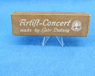 Lot 186. Gebr. Ludwig full concert harmonica in the key of G with the box in excellent condition.