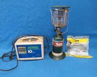 Lot 77. Propane lantern, battery charger, and a new dryer power cord