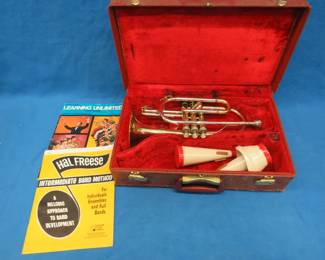Lot 10. Frank Horton Model C301 trumpet. Good used condition. Valves work good. Includes two mutes, case, and instruction books.