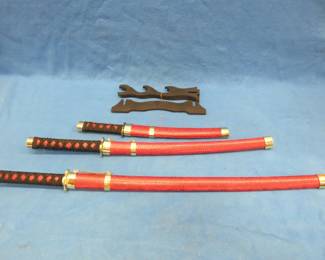 Lot 372. Three-sword set with scabbards and display stand