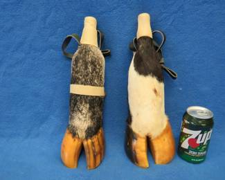 Lot 149. Cow hooves repurposed as bottle holders complete with bottles