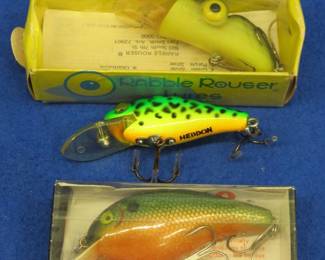 Lot 392. Heddon Timber Rattler, Cotton Cordell Big O in the box with papers, and a Rabble Rouser in the box with papers