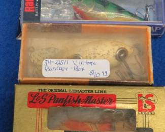 Lot 391. Vintage 2" wooden Bomber in a box marked 311, NIP Rapala 2 3/8" Glass Shad Rap, and an L & S Lures MirrOlure Sinker in a box with papers marked 0018.